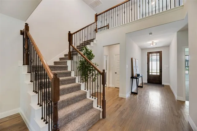 a view of entryway with wooden floor and stairs