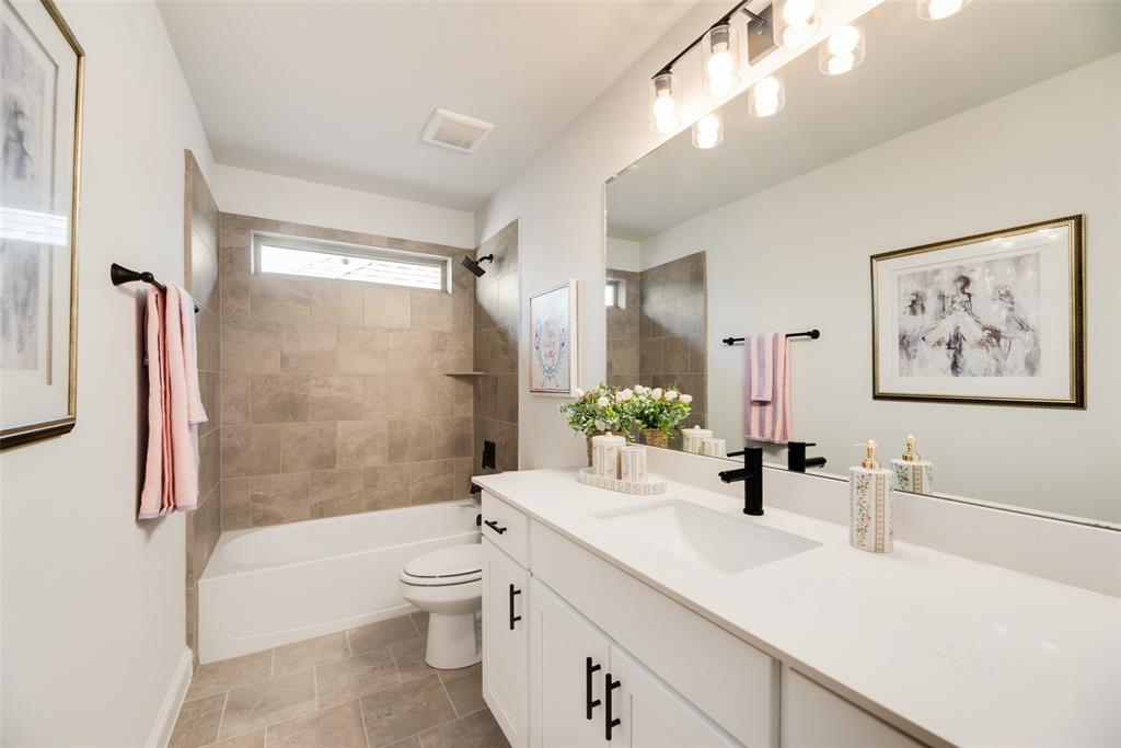 5220 Picasso Road Royse City, TX 75189 - Photo 25 of 28 a bathroom with a double vanity sink toilet and shower