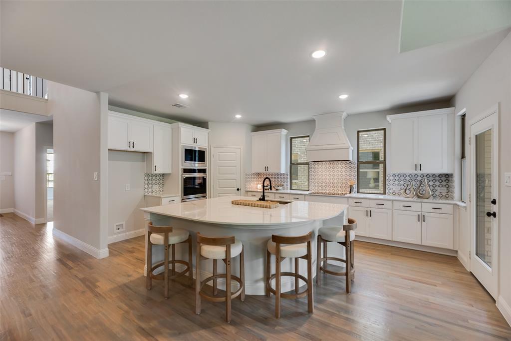5220 Picasso Road Royse City, TX 75189 - Photo 5 of 28 a kitchen with stainless steel appliances granite countertop a table chairs sink refrigerator and cabinets