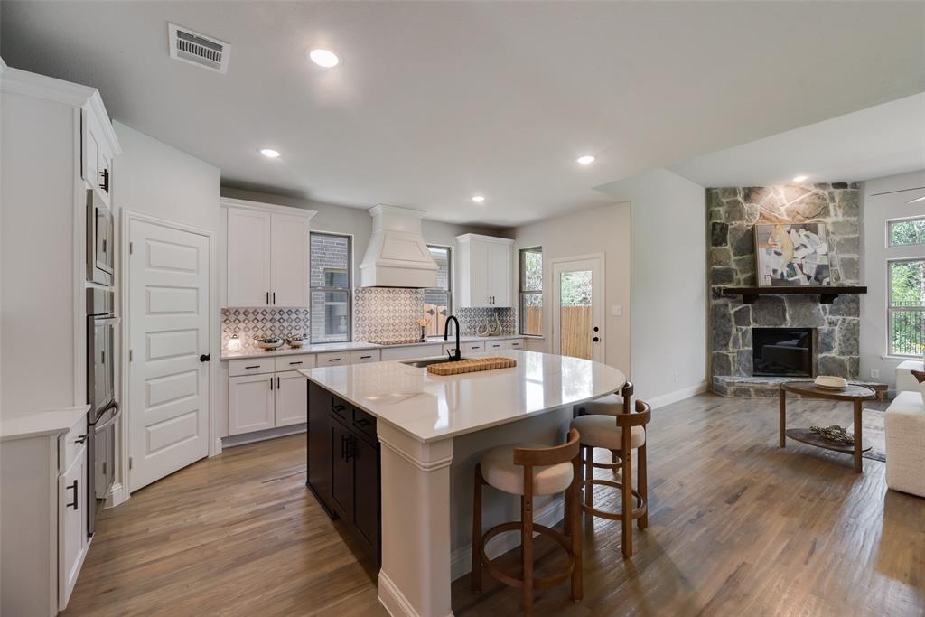 5220 Picasso Road Royse City, TX 75189 - Photo 6 of 28 a open kitchen with stainless steel appliances granite countertop a stove refrigerator and a fireplace