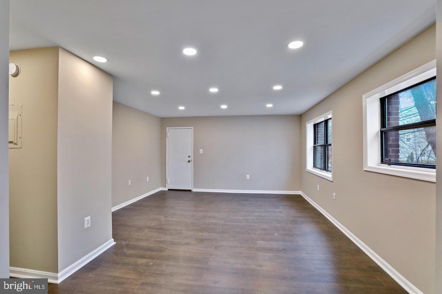 3287 15th Place Southeast, Unit 101 Washington, DC 20020 - Photo 2 of 16 a view of an empty room with wooden floor and entryway