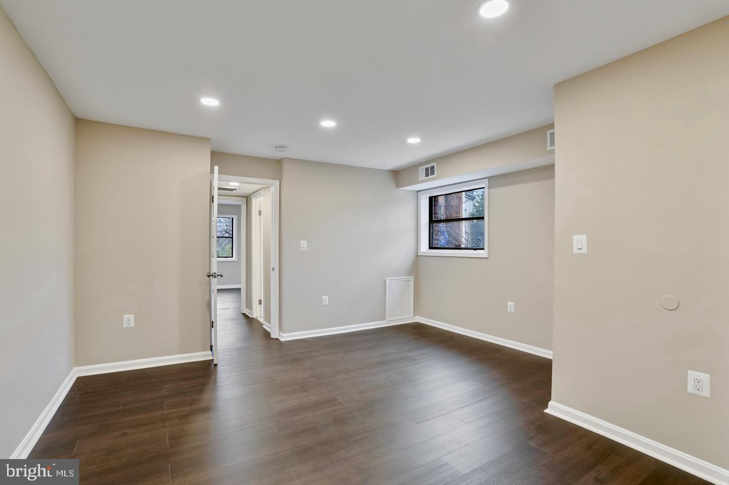 3287 15th Place Southeast, Unit 101 Washington, DC 20020 - Photo 8 of 16 a view of an empty room with wooden floor