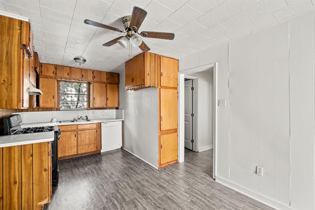 1040 Clinton Avenue Stephenville, TX 76401 - Photo 12 of 26 a kitchen with a refrigerator a sink and a stove