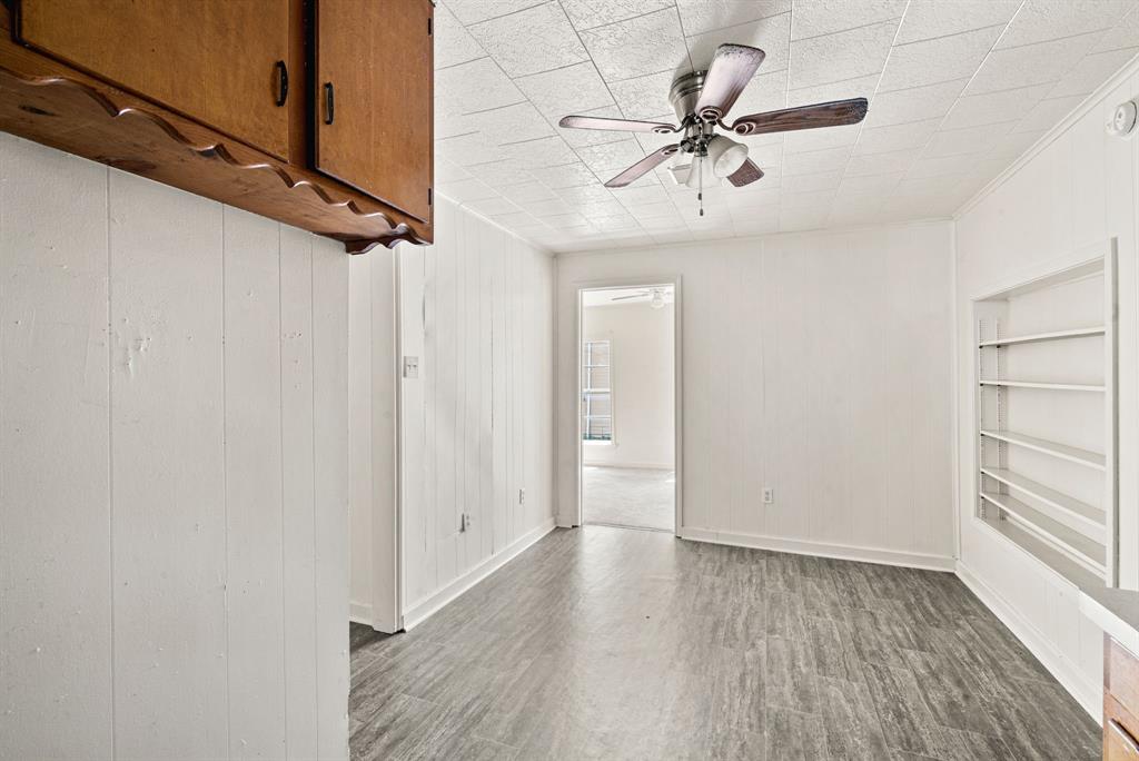 1040 Clinton Avenue Stephenville, TX 76401 - Photo 15 of 26 wooden floor in an empty room with a window