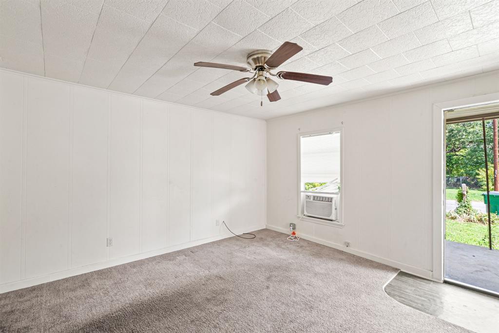 1040 Clinton Avenue Stephenville, TX 76401 - Photo 20 of 26 an empty room with windows and fan