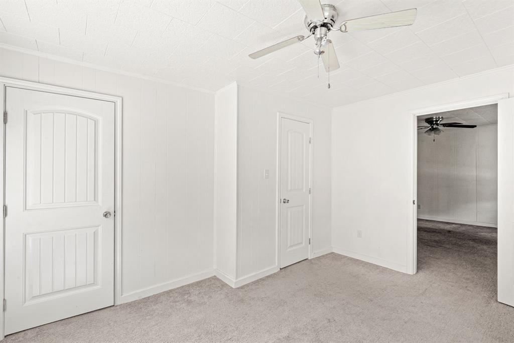 1040 Clinton Avenue Stephenville, TX 76401 - Photo 24 of 26 an empty room with a ceiling fan and a window