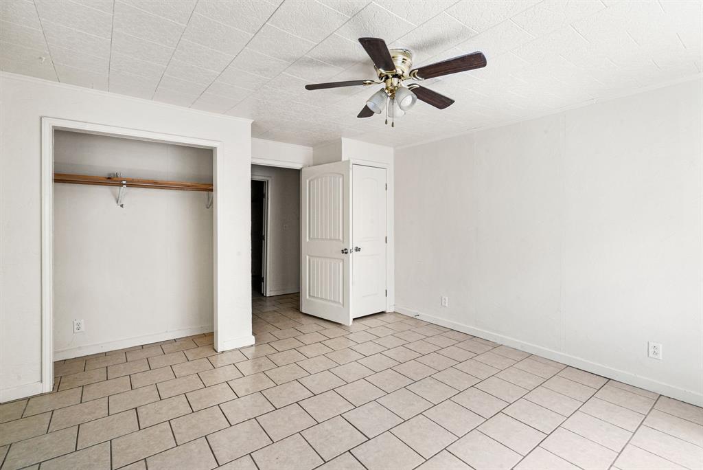 1040 Clinton Avenue Stephenville, TX 76401 - Photo 10 of 26 an empty room with closet and fan