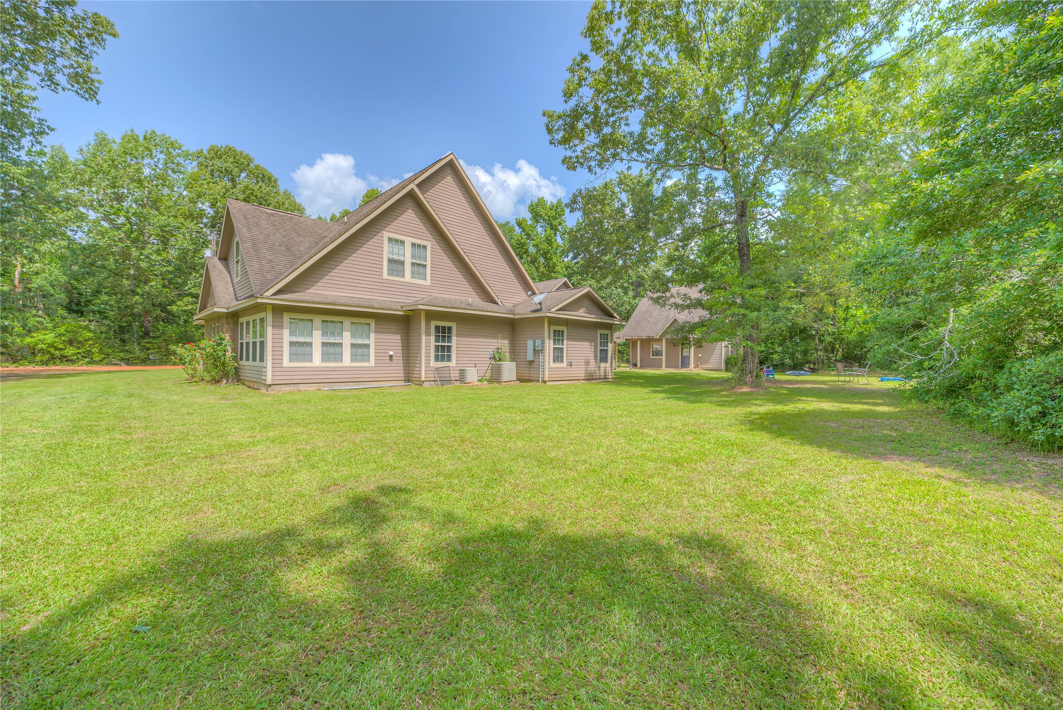 110 Happy Trails Road Coldspring, TX 77331 - Photo 33 of 49 a front view of a house with a garden and yard