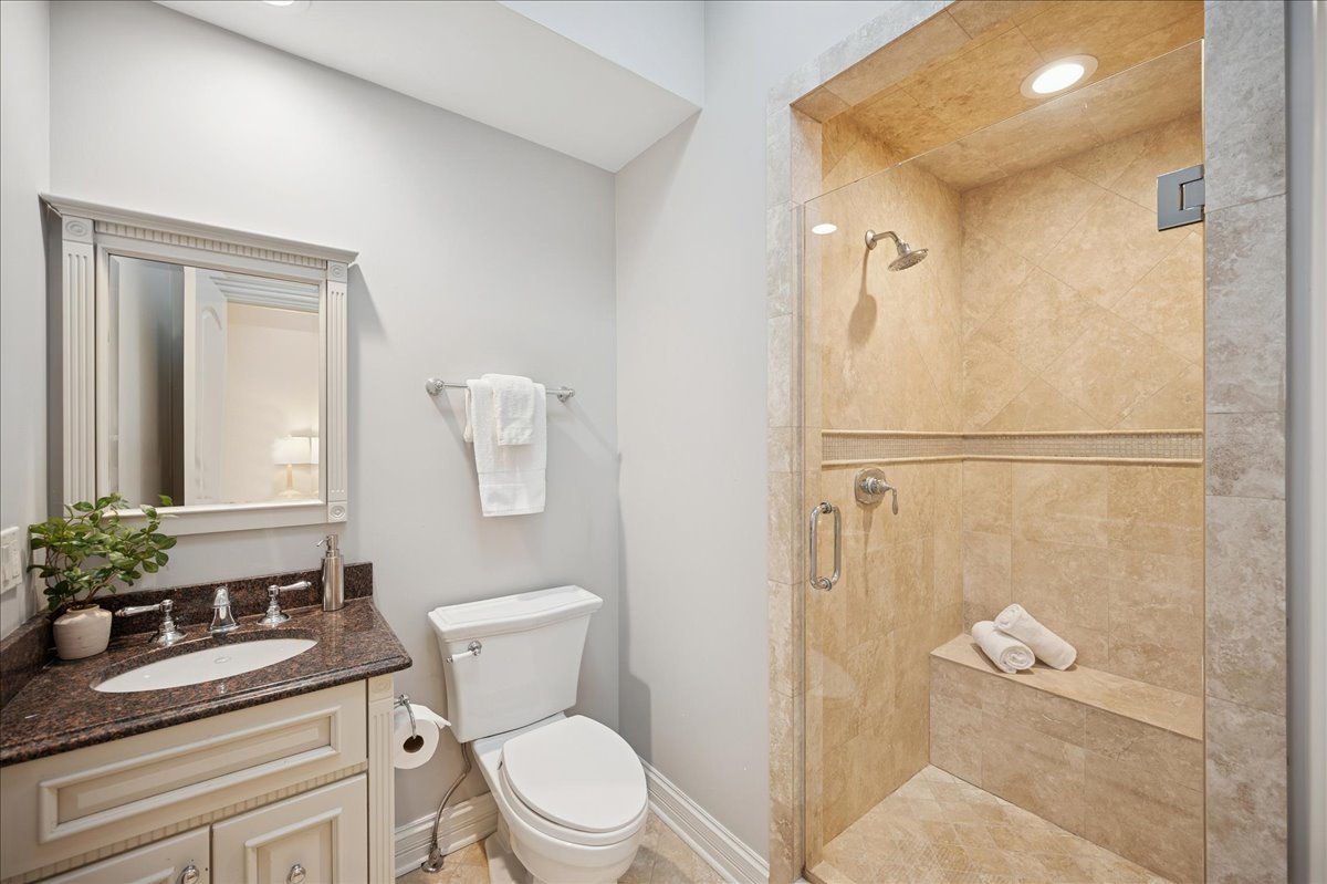 520 Provident Avenue Winnetka, IL 60093 - Photo 24 of 41 a bathroom with a granite countertop sink a toilet and shower