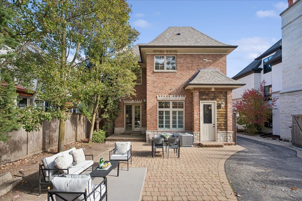 520 Provident Avenue Winnetka, IL 60093 - Photo 36 of 41 a view of a brick house with chairs and table in a patio