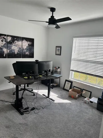a living room with furniture a window and a flat screen tv