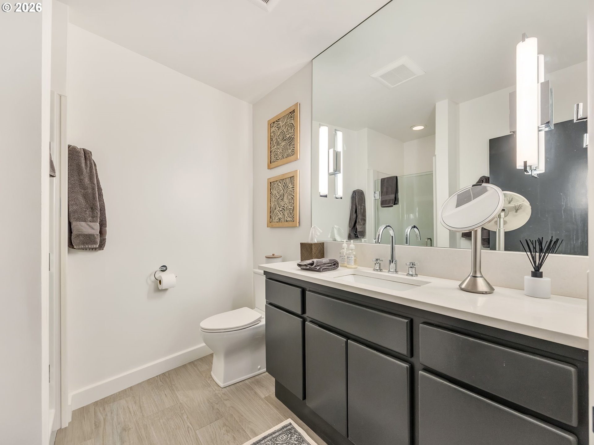 101 13th Street, Unit 211 Gearhart, OR 97138 - Photo 14 of 24 a bathroom with a double vanity sink toilet and a mirror