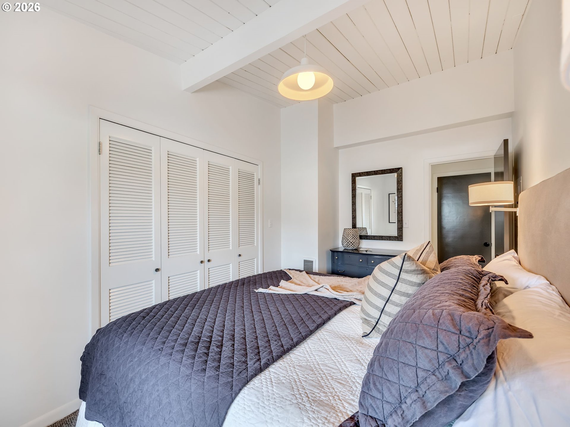 101 13th Street, Unit 211 Gearhart, OR 97138 - Photo 15 of 24 a bedroom with a bed and painting on the wall