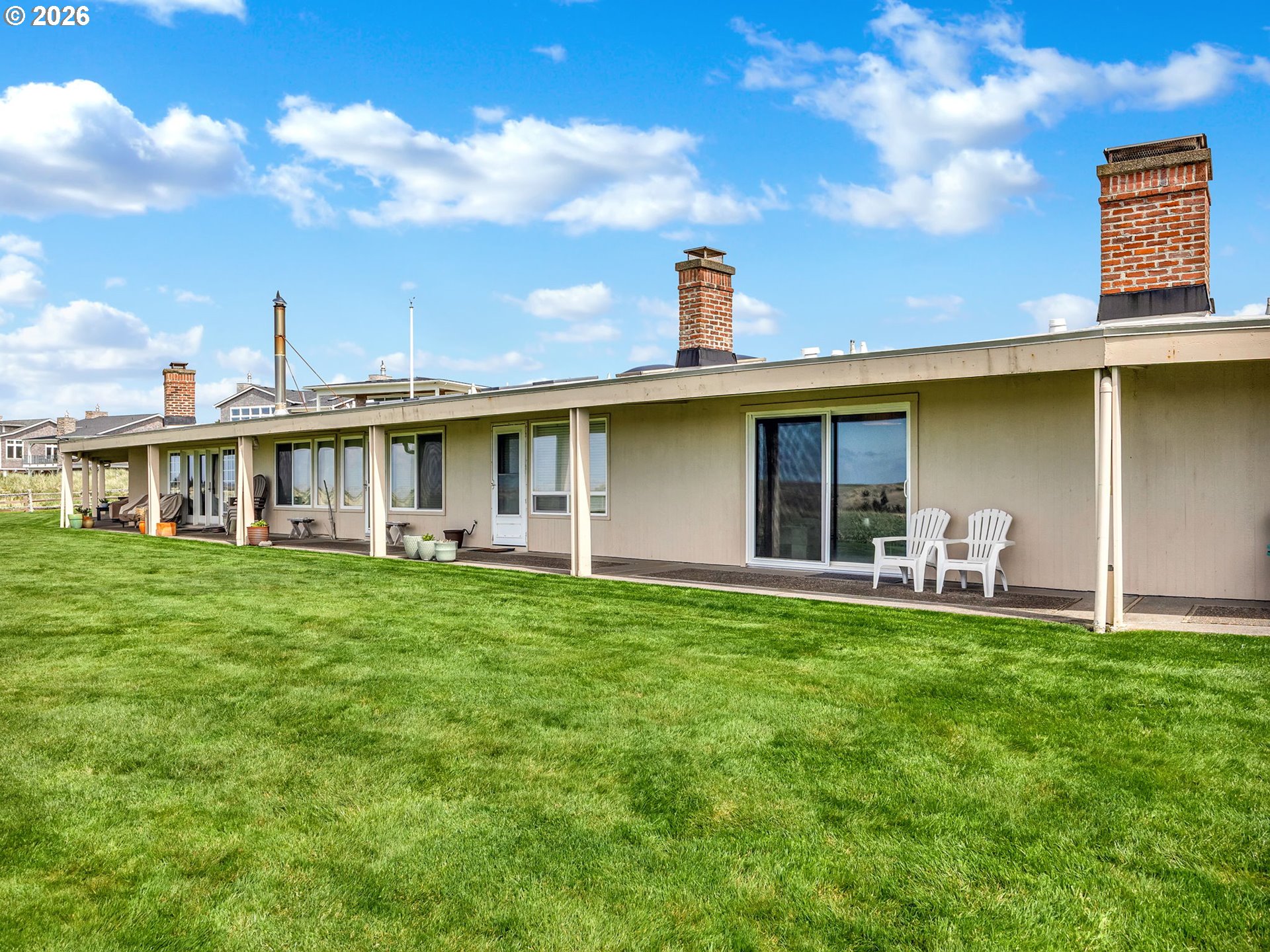 101 13th Street, Unit 211 Gearhart, OR 97138 - Photo 20 of 24 a view of a house with a backyard