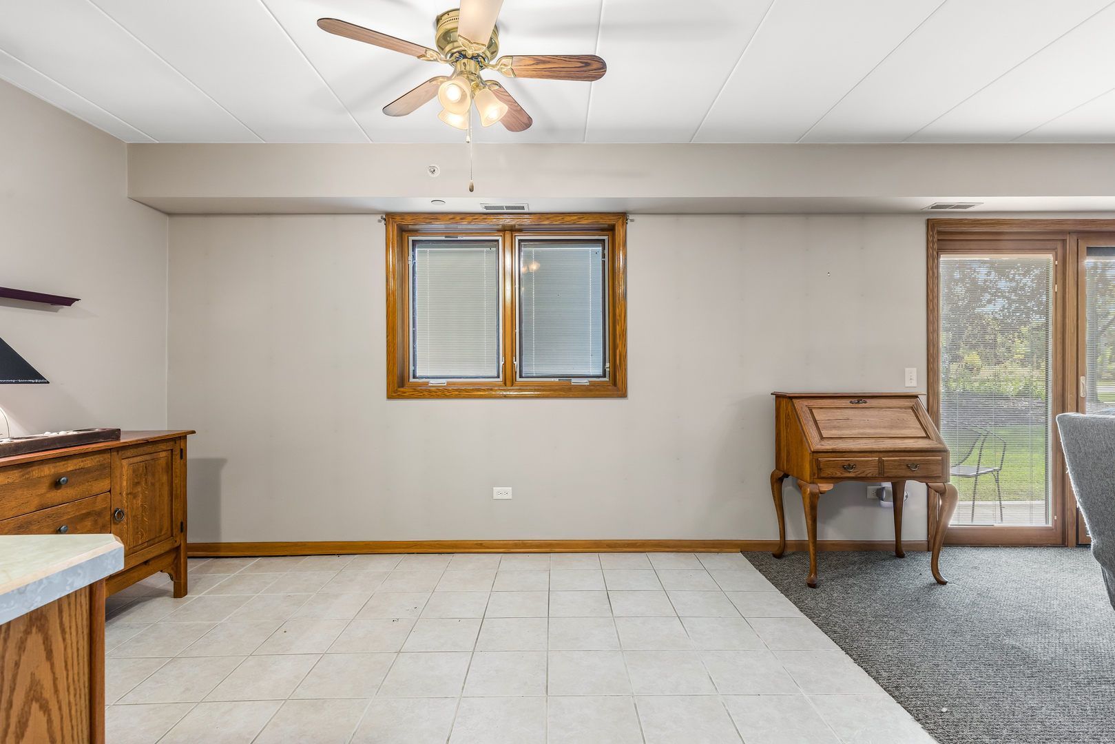6820 Winding Trail, Unit 101 Oak Forest, IL 60452 - Photo 11 of 21 a view of an empty room with a window and a chandelier fan