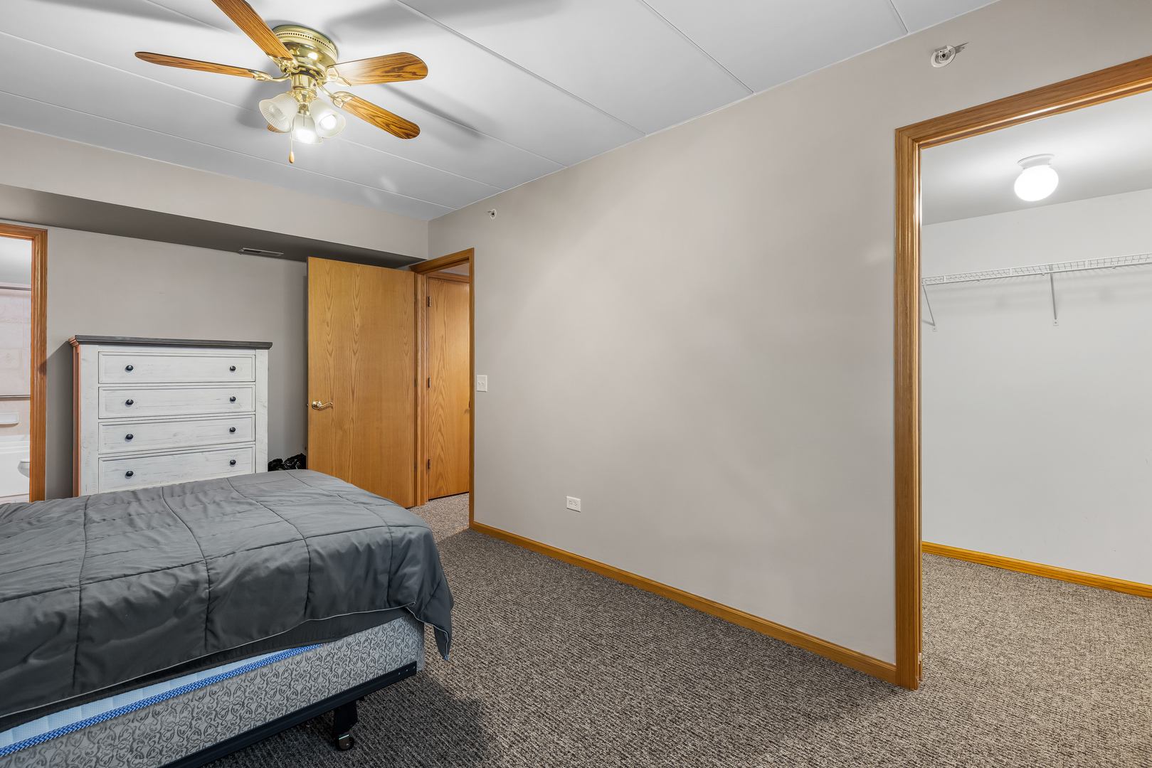 6820 Winding Trail, Unit 101 Oak Forest, IL 60452 - Photo 14 of 21 a bedroom with a bed and a chandelier