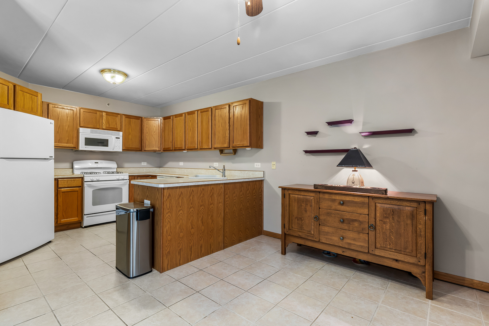 6820 Winding Trail, Unit 101 Oak Forest, IL 60452 - Photo 9 of 21 a kitchen with a refrigerator sink and cabinets