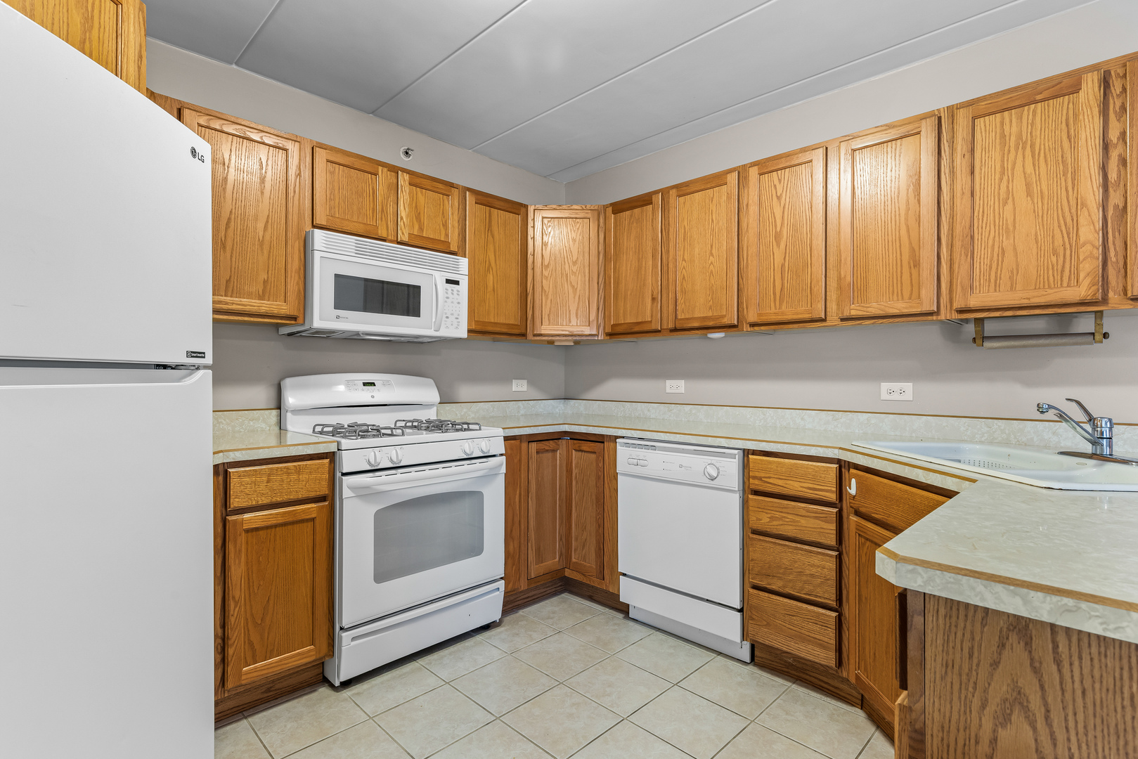 6820 Winding Trail, Unit 101 Oak Forest, IL 60452 - Photo 10 of 21 a kitchen with stainless steel appliances granite countertop a stove a sink and a microwave