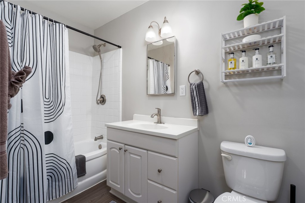 716 Orange Street Riverside, CA 92501 - Photo 15 of 28 a bathroom with a toilet sink and mirror