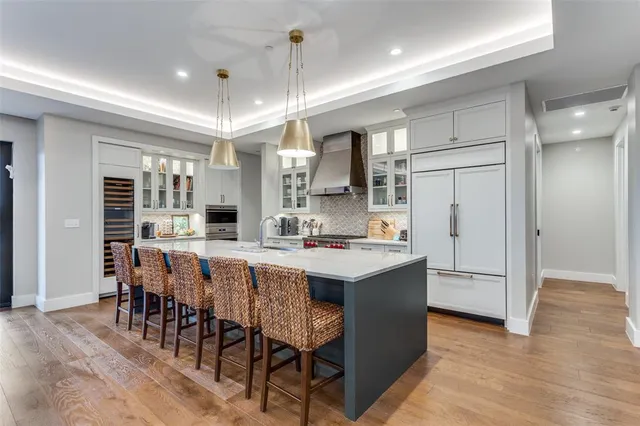 a large kitchen with a table and chairs