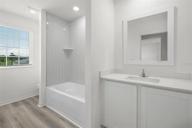 a bathroom with a bathtub and a sink