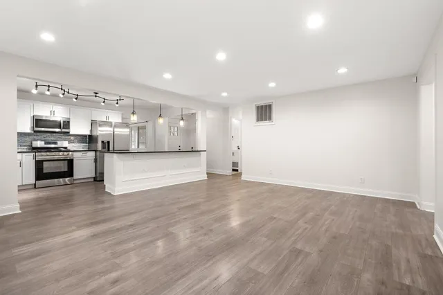 a view of a kitchen with a sink and a stove top oven