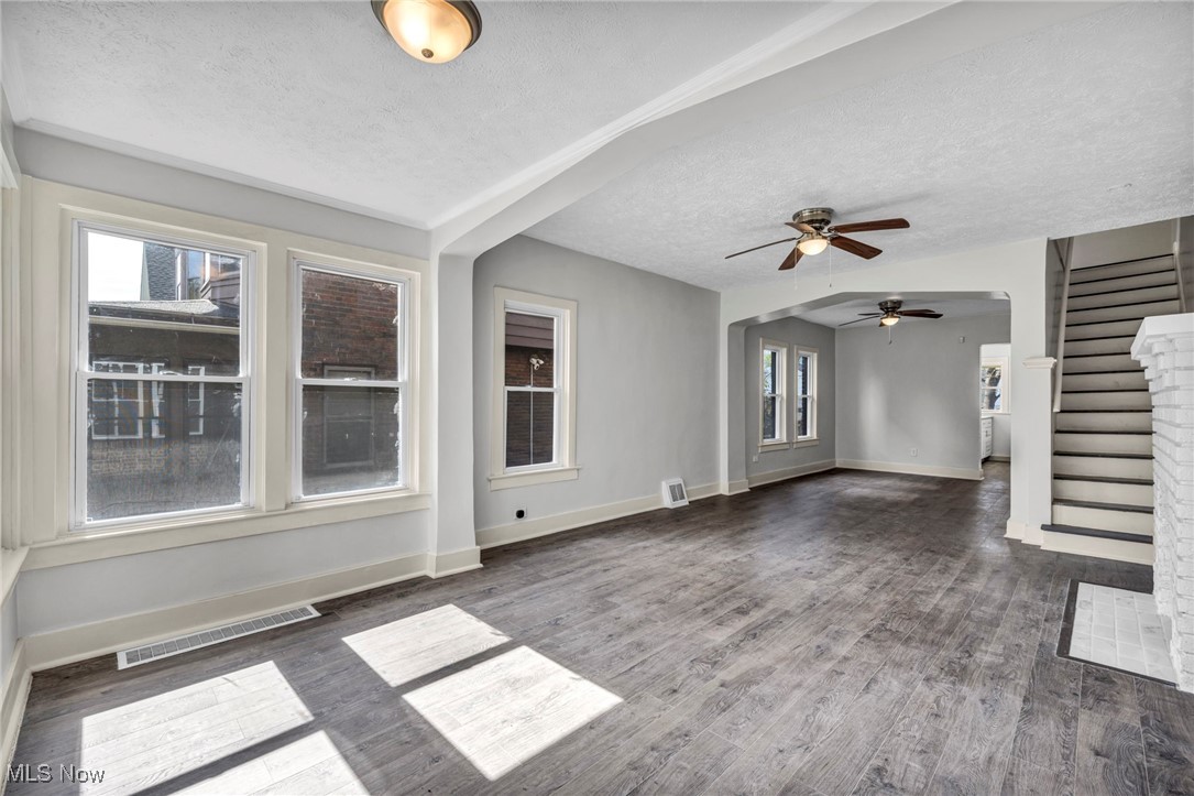 3239 Sycamore Road Cleveland, OH 44118 - Photo 22 of 49 Unfurnished living room featuring wood finished floors, ceiling fan, a textured ceiling, and visible vents