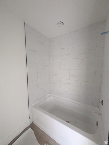 2771 West Aurora Avenue Mapleton, UT 84664 - Photo 29 of 39 White tile surround with subtle veining and a recessed ceiling light fixture