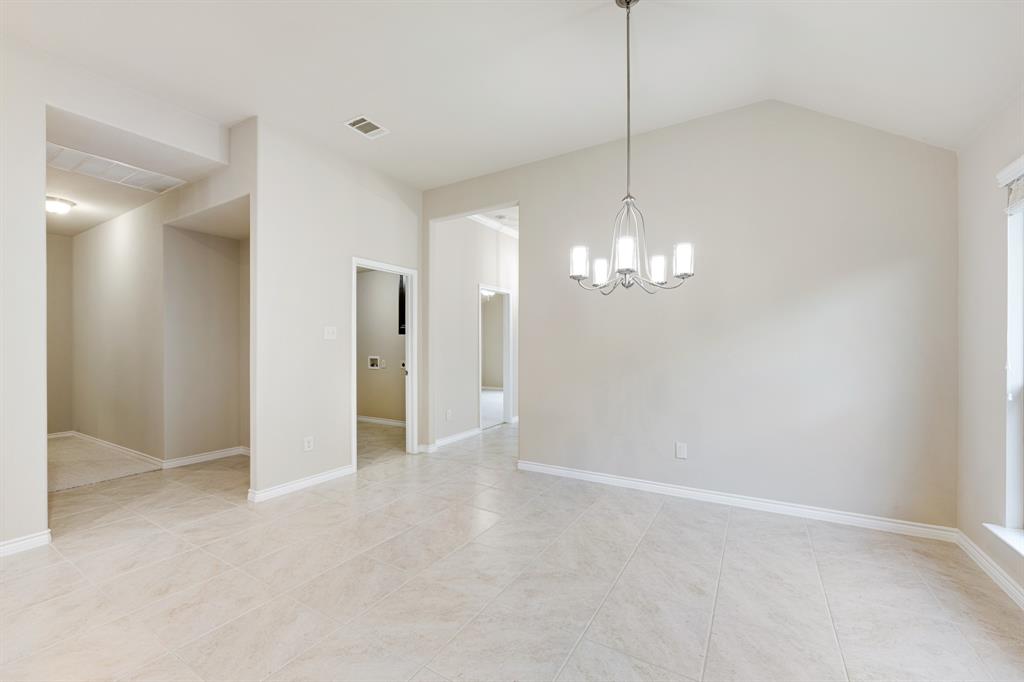 5022 Hidden Creek Road Garland, TX 75043 - Photo 14 of 36 a view of a chandelier in big room and chandelier fan