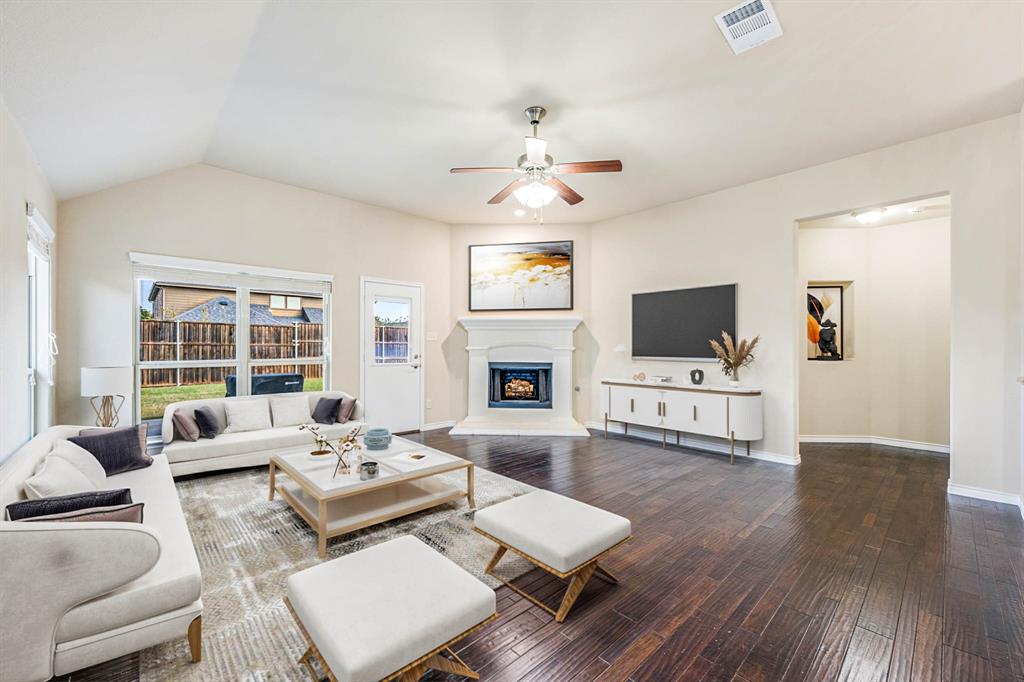 5022 Hidden Creek Road Garland, TX 75043 - Photo 16 of 36 a living room with furniture a flat screen tv and a fireplace