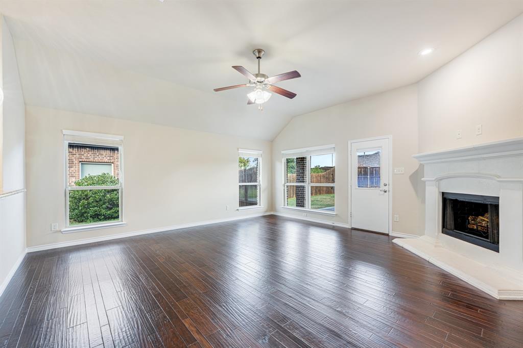 5022 Hidden Creek Road Garland, TX 75043 - Photo 19 of 36 a view of an empty room with wooden floor and a window
