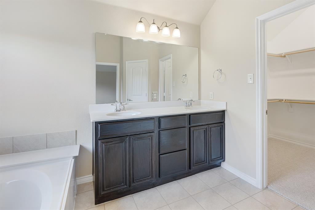 5022 Hidden Creek Road Garland, TX 75043 - Photo 24 of 36 a bathroom with a sink and a mirror