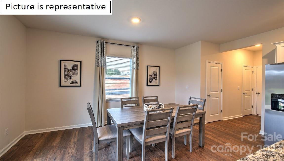 142 Flame Azalea Court Locust, NC 28097 - Photo 20 of 40 a view of a dining room with furniture and wooden floor