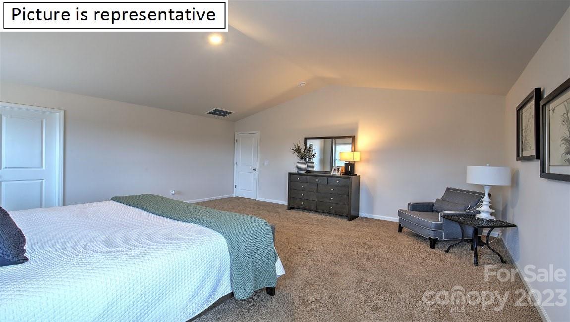 142 Flame Azalea Court Locust, NC 28097 - Photo 28 of 40 a spacious bedroom with a bed and a chair in it