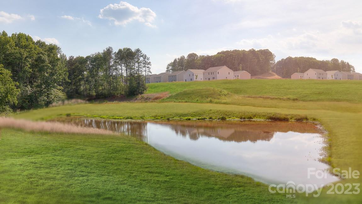 142 Flame Azalea Court Locust, NC 28097 - Photo 39 of 40 a view of a lake with a mountain in the background
