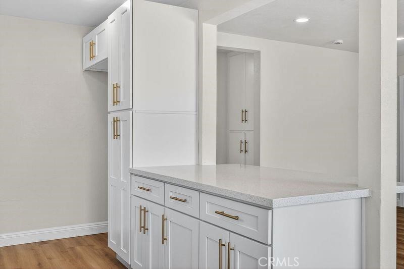 18222 10th Street Bloomington, CA 92316 - Photo 11 of 22 a view of cabinets and wooden floor