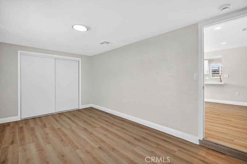 18222 10th Street Bloomington, CA 92316 - Photo 12 of 22 wooden floor in an empty room