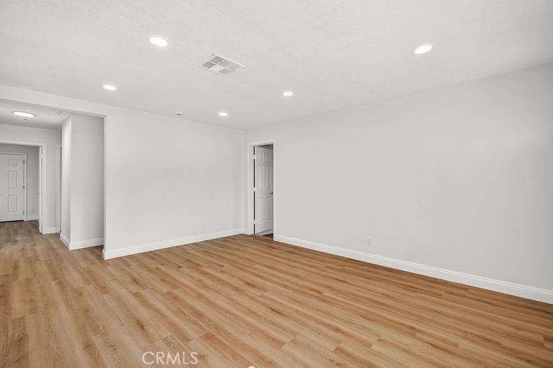 18222 10th Street Bloomington, CA 92316 - Photo 3 of 22 a view of an empty room with wooden floor