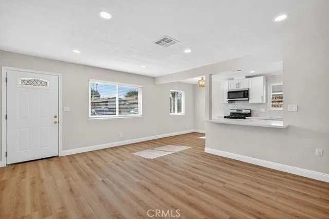 a view of kitchen with sink and wooden floor