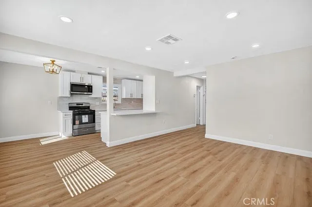 a view of kitchen with sink and refrigerator