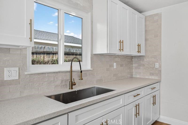 18222 10th Street Bloomington, CA 92316 - Photo 9 of 22 a kitchen with a sink and cabinets