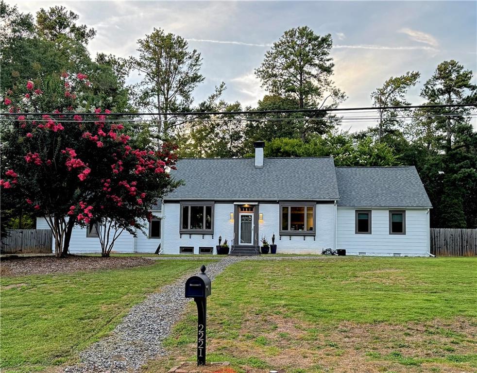 a front view of house with yard and trees