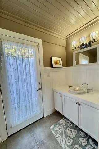 a white tub sitting next to a bathroom