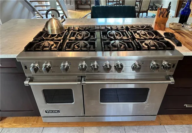 a large kitchen with a refrigerator and a sink