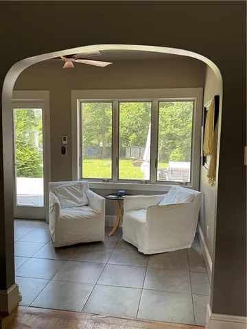 a room with table chairs and painting on the wall