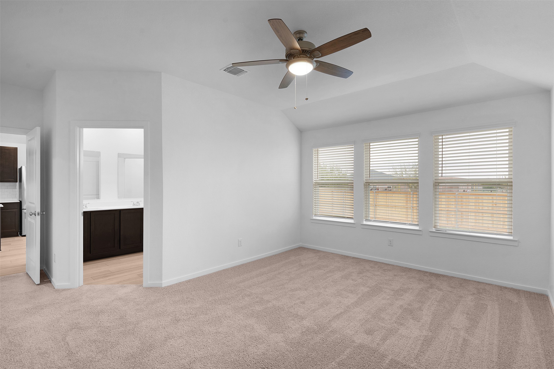 13721 Tucker Hedge Pass Elgin, TX 78621 - Photo 14 of 28 Unfurnished room featuring light colored carpet, ceiling fan, and vaulted ceiling