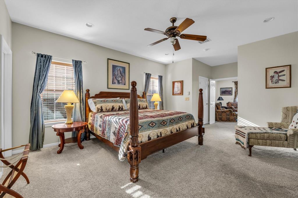 3439 Willow Branch Road McGregor, TX 76657 - Photo 14 of 40 a bedroom with a bed and a chandelier