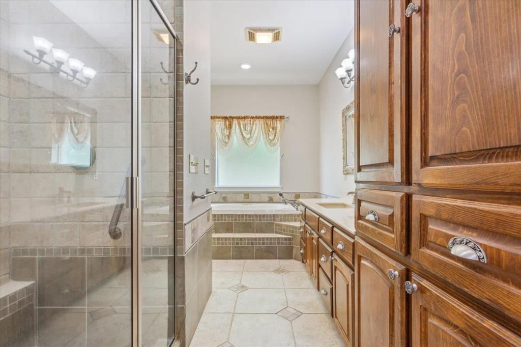 3439 Willow Branch Road McGregor, TX 76657 - Photo 17 of 40 a bathroom with a tub sink and mirror