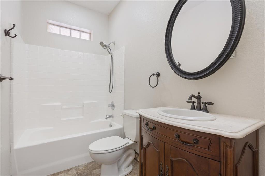 3439 Willow Branch Road McGregor, TX 76657 - Photo 19 of 40 a bathroom with a sink a toilet and a mirror