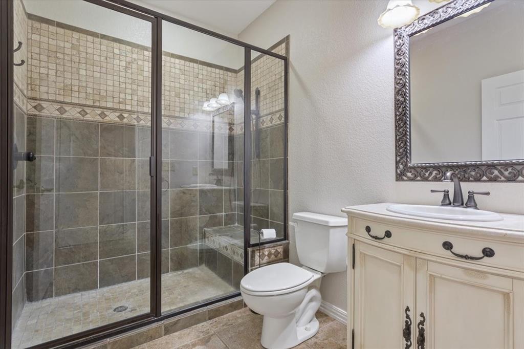 3439 Willow Branch Road McGregor, TX 76657 - Photo 21 of 40 a bathroom with a shower a toilet and a sink